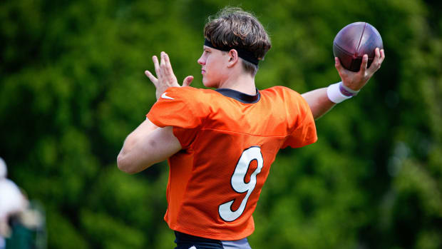 Joe Burrow brings his arm back to throw the ball at training camp